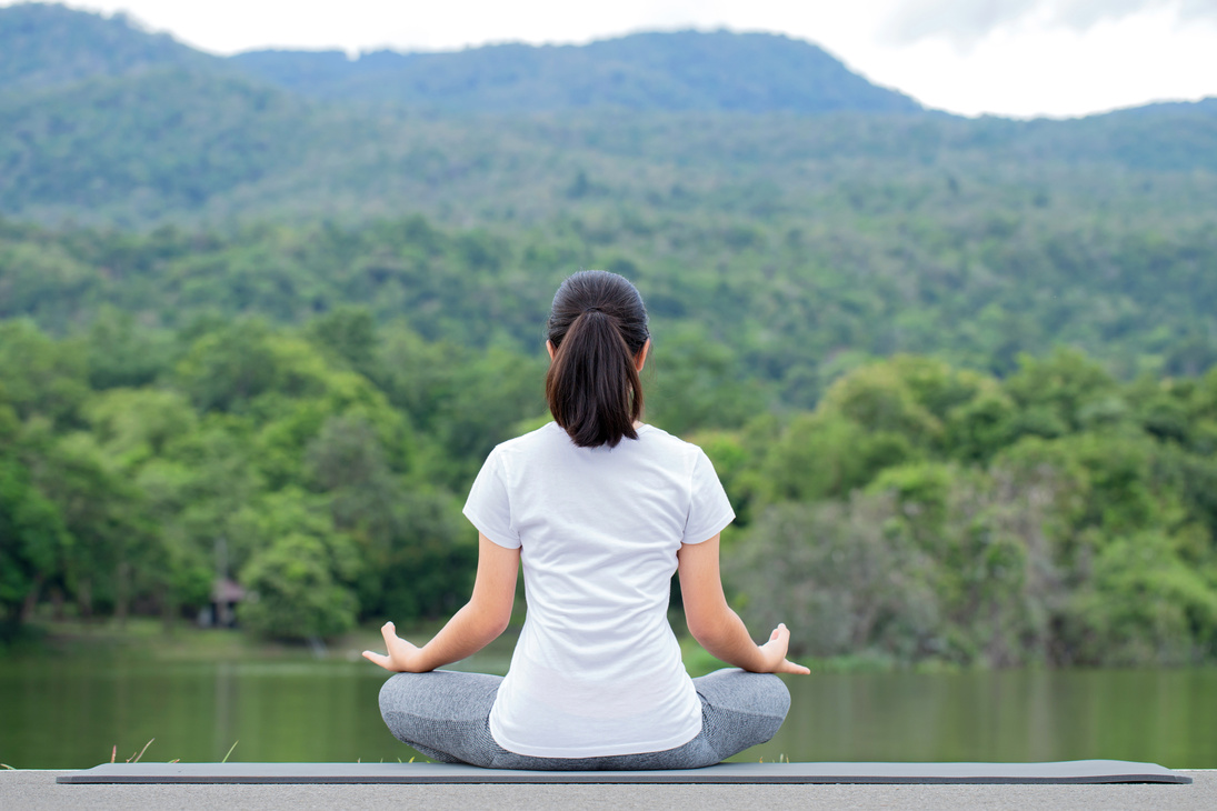 Young Woman Practicing Yoga in Nature